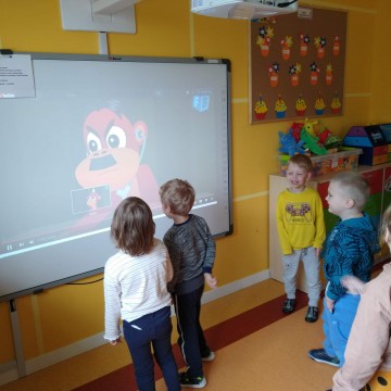 Dzieci przy tablicy multimedialnej